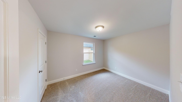 unfurnished room featuring carpet