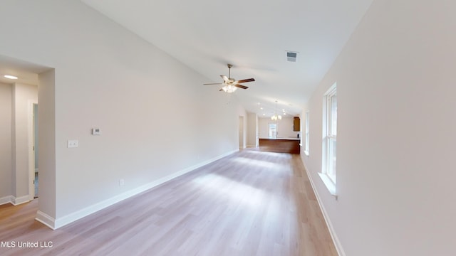 unfurnished living room with vaulted ceiling, light hardwood / wood-style flooring, and ceiling fan