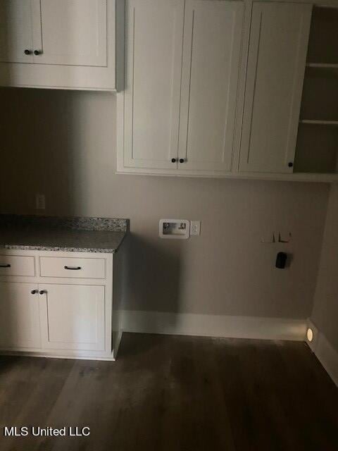 washroom featuring cabinets, hookup for an electric dryer, washer hookup, and dark hardwood / wood-style flooring