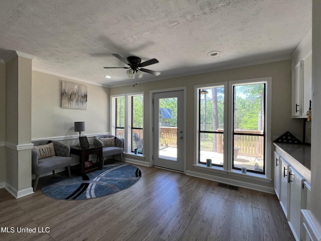 110 Hawks Nest Cv, Brandon, MS 39042 - living area featuring dark wood-style flooring, crown molding, a textured ceiling, ceiling fan, and recessed lighting