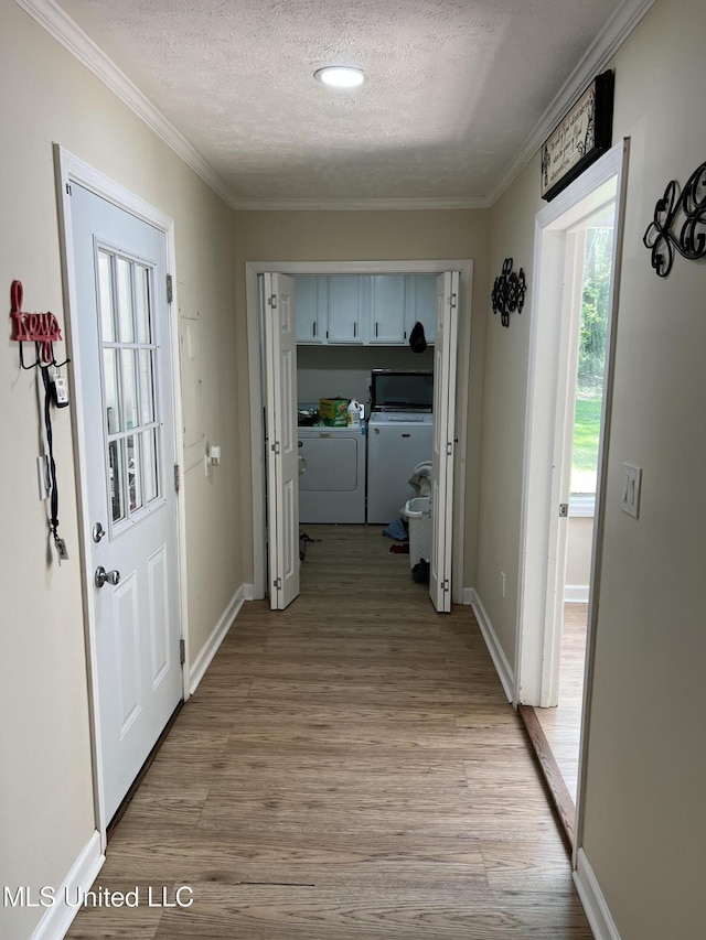 110 Hawks Nest Cv, Brandon, MS 39042 - hall featuring independent washer and dryer, a textured ceiling, light wood-style floors, and crown molding