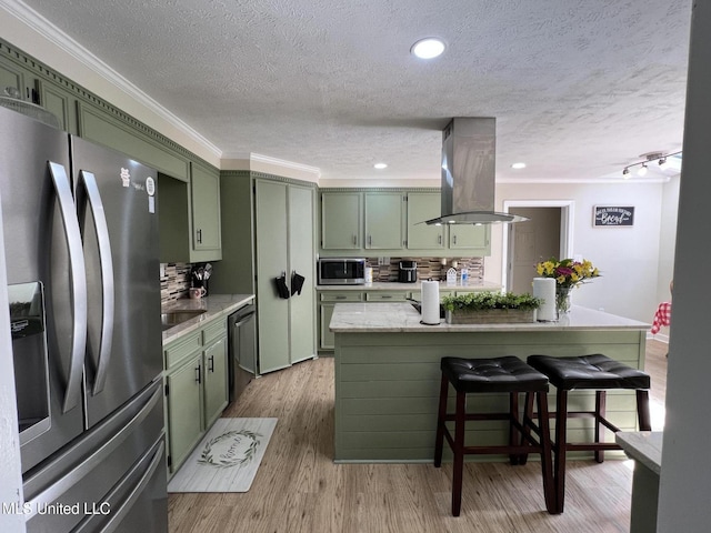 110 Hawks Nest Cv, Brandon, MS 39042 - kitchen with green cabinets, stainless steel appliances, island range hood, a textured ceiling, and a breakfast bar