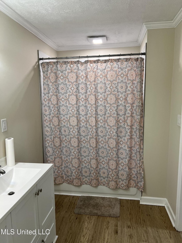 110 Hawks Nest Cv, Brandon, MS 39042 - full bath with vanity, wood finished floors, shower / tub combo with curtain, crown molding, and a textured ceiling