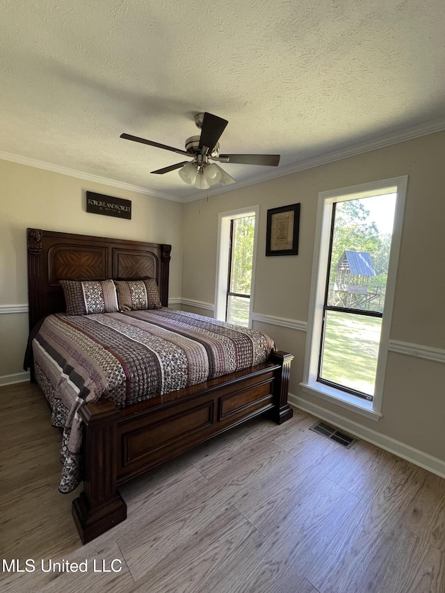 110 Hawks Nest Cv, Brandon, MS 39042 - bedroom featuring wood finished floors, a textured ceiling, ornamental molding, and a ceiling fan