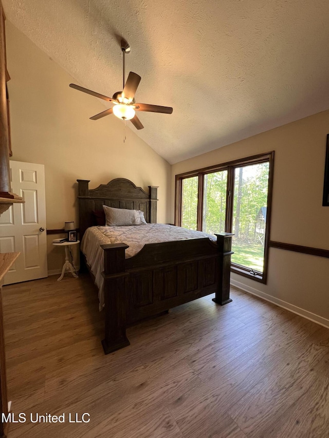 110 Hawks Nest Cv, Brandon, MS 39042 - bedroom featuring a textured ceiling, wood finished floors, lofted ceiling, and a ceiling fan
