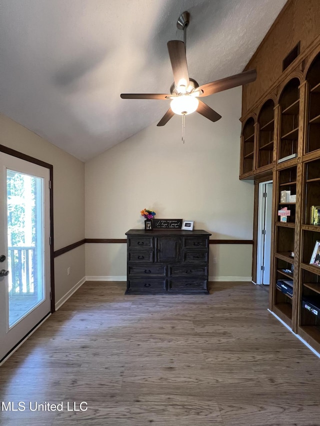 110 Hawks Nest Cv, Brandon, MS 39042 - unfurnished living room featuring vaulted ceiling, a ceiling fan, and wood finished floors
