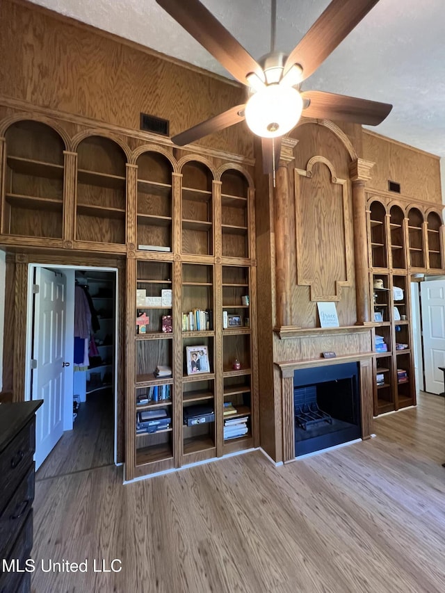 110 Hawks Nest Cv, Brandon, MS 39042 - unfurnished living room with a ceiling fan, wood finished floors, and a fireplace