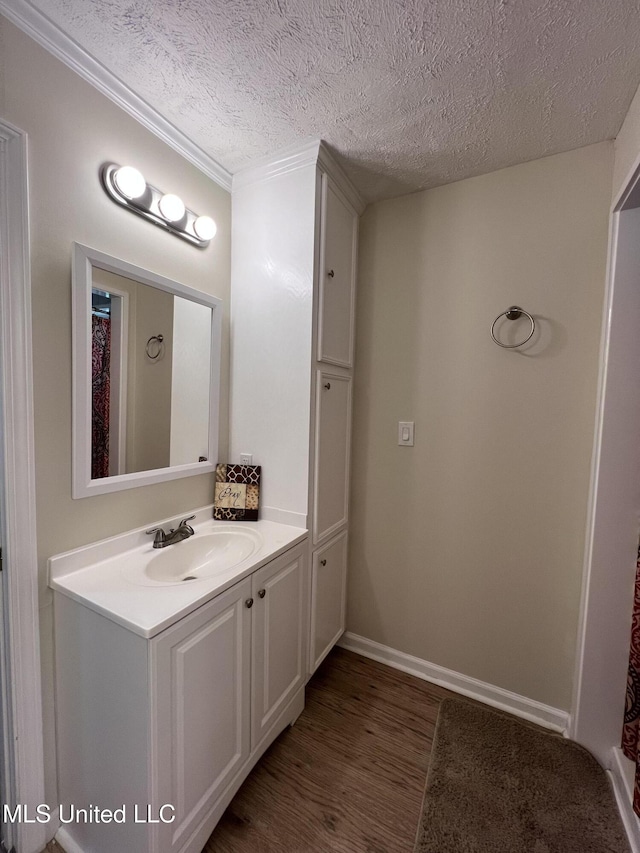 110 Hawks Nest Cv, Brandon, MS 39042 - bathroom with wood finished floors, vanity, a textured ceiling, and crown molding