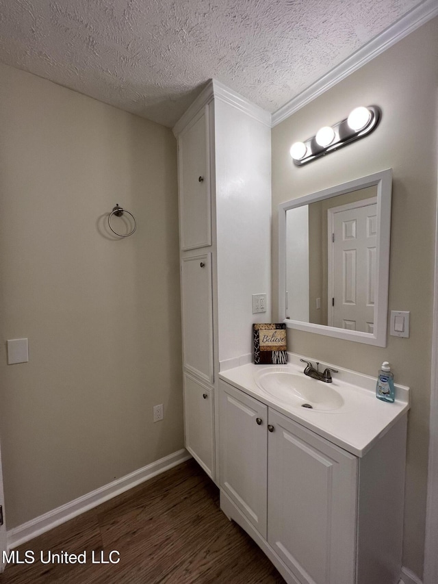 110 Hawks Nest Cv, Brandon, MS 39042 - bathroom featuring wood finished floors, vanity, a textured ceiling, and crown molding