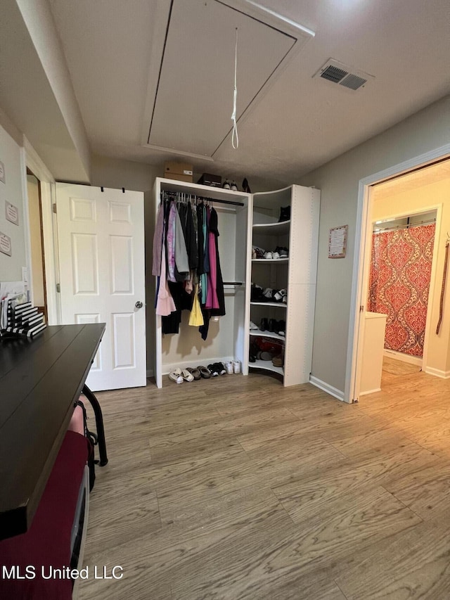 110 Hawks Nest Cv, Brandon, MS 39042 - bedroom featuring attic access, wood finished floors, and a closet