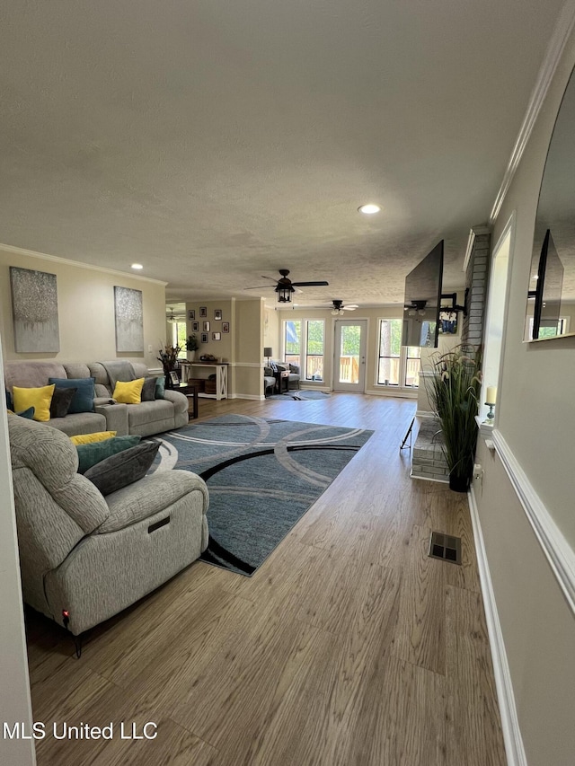 110 Hawks Nest Cv, Brandon, MS 39042 - living room featuring ornamental molding, a ceiling fan, wood finished floors, and recessed lighting