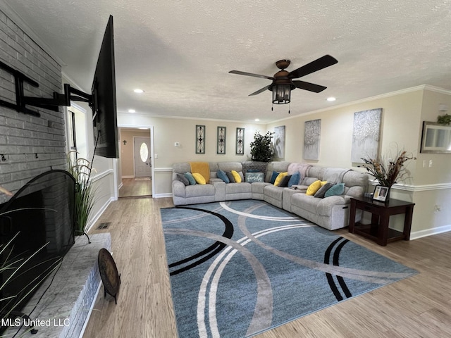 110 Hawks Nest Cv, Brandon, MS 39042 - living area with a ceiling fan, wood finished floors, a textured ceiling, recessed lighting, and ornamental molding