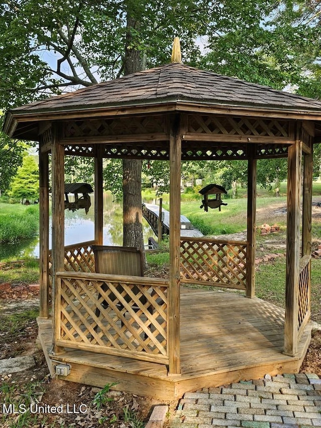 wooden deck featuring a gazebo and a water view