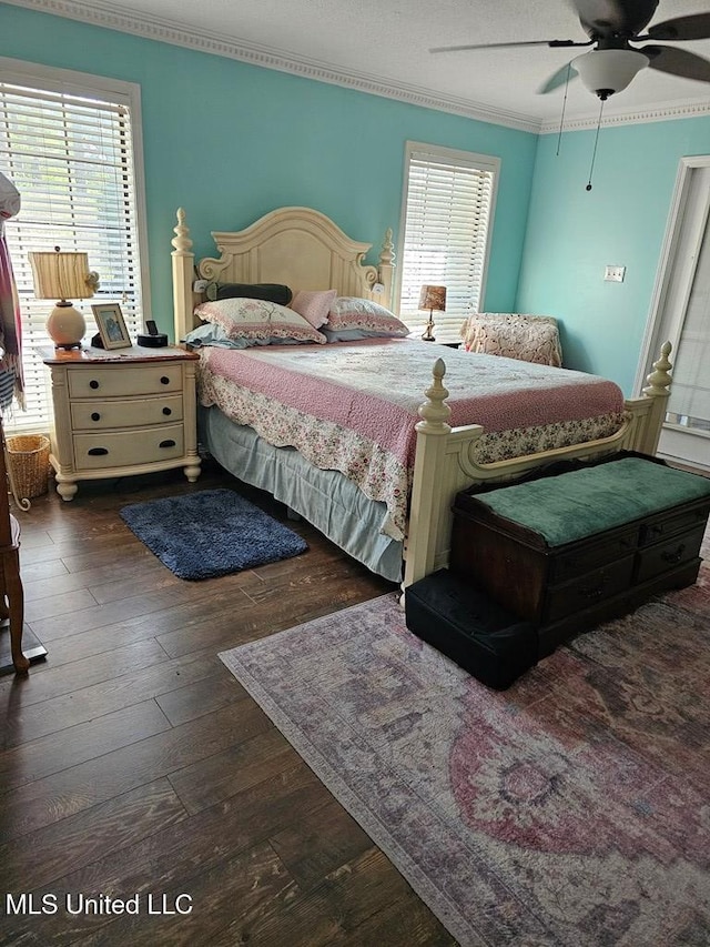 bedroom with ceiling fan, dark hardwood / wood-style flooring, and ornamental molding