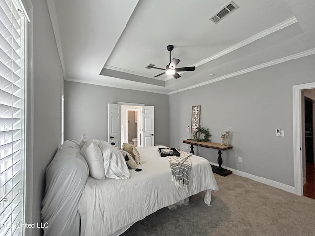 bedroom with carpet floors, a raised ceiling, ceiling fan, and ornamental molding