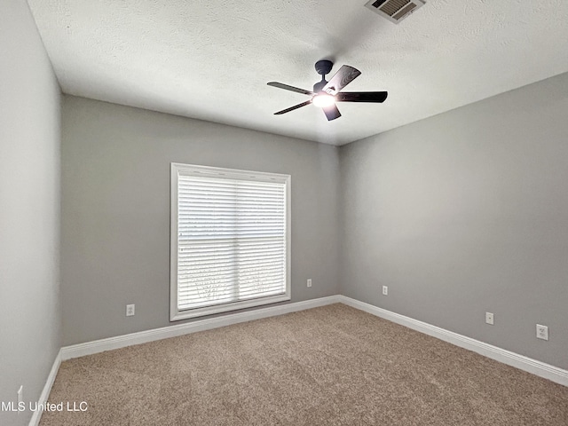 unfurnished room with ceiling fan, carpet floors, and a textured ceiling