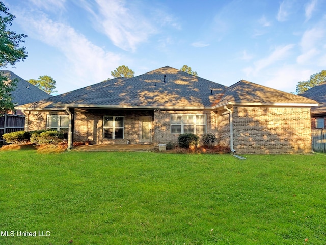 rear view of house with a yard