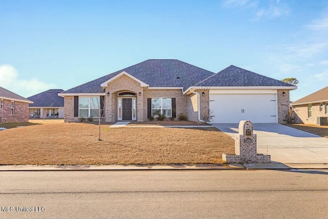 single story home featuring a garage and cooling unit