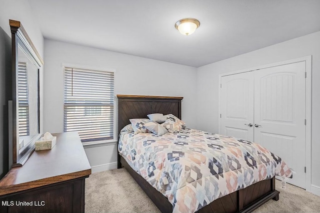 bedroom featuring light colored carpet and a closet