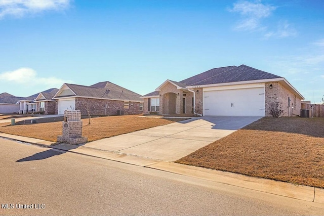 ranch-style house with a garage and central air condition unit