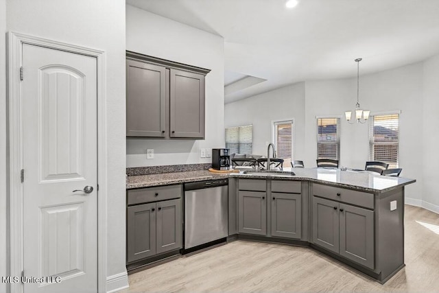 kitchen featuring light hardwood / wood-style floors, dishwasher, sink, and kitchen peninsula