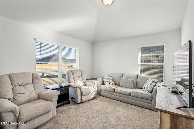 living room with lofted ceiling and carpet floors