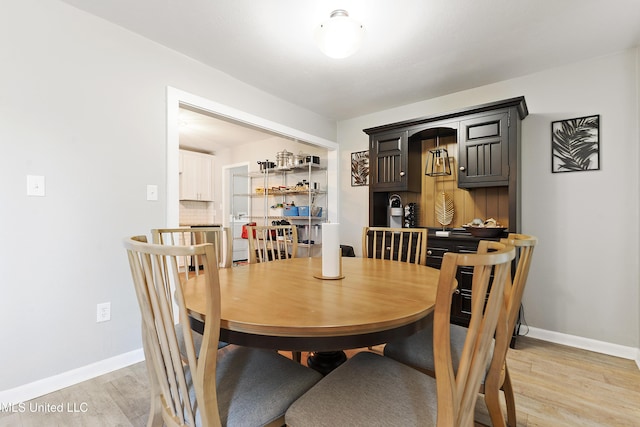 dining space featuring light wood-type flooring