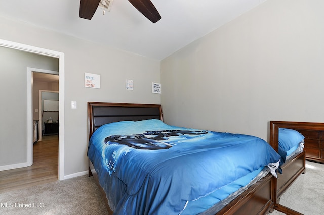 bedroom with ceiling fan and light colored carpet