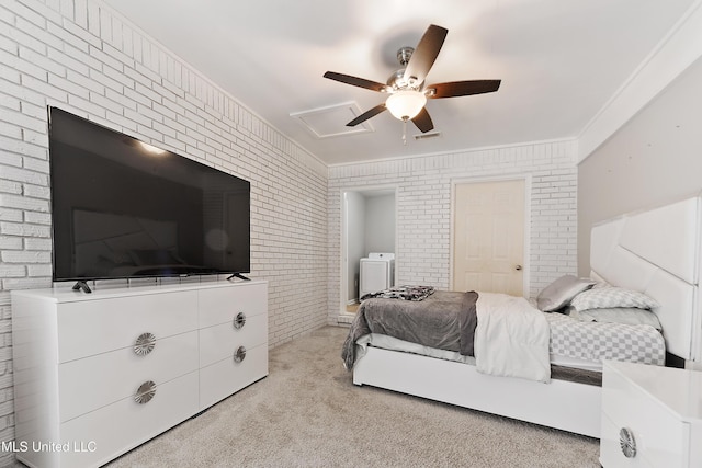 carpeted bedroom featuring washer / dryer, ceiling fan, ornamental molding, and brick wall