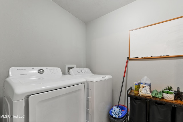 clothes washing area featuring washer and dryer