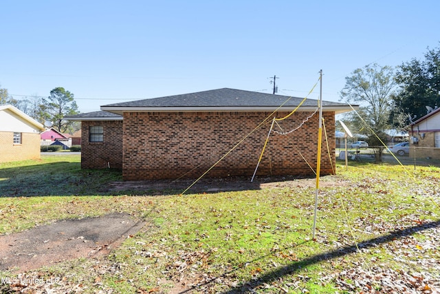 rear view of house with a yard