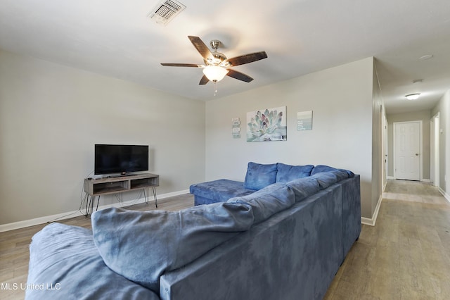 living room featuring ceiling fan and hardwood / wood-style floors