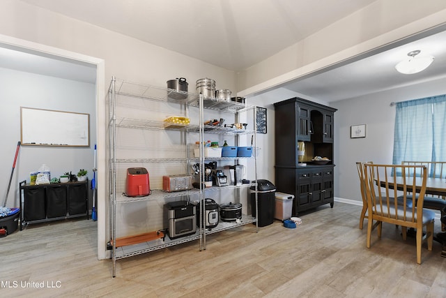 dining space with wood-type flooring