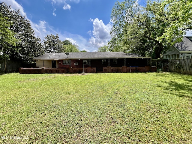111 E Gresham St, Indianola, MS 38751 - rear view of property featuring a lawn, a fenced backyard, and brick siding