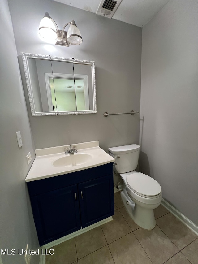 111 E Gresham St, Indianola, MS 38751 - half bathroom with toilet, visible vents, tile patterned flooring, and vanity