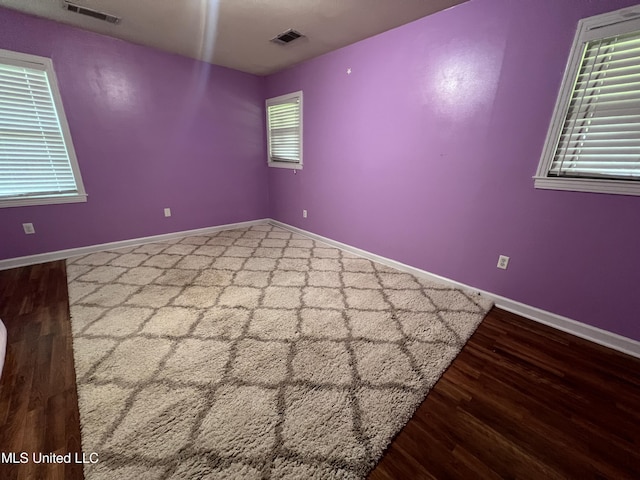 111 E Gresham St, Indianola, MS 38751 - empty room featuring baseboards, wood finished floors, and visible vents