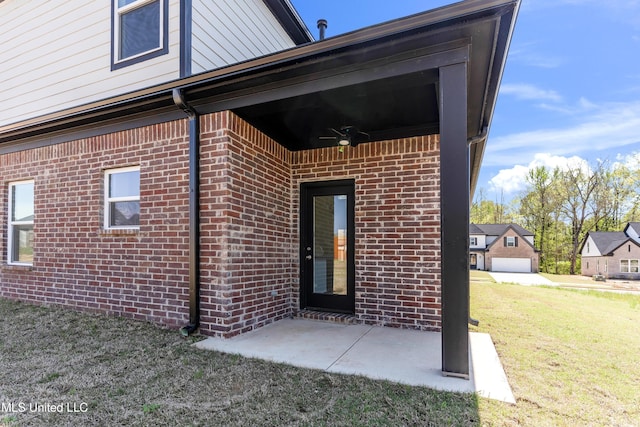 10243 March Meadows Way, Olive Branch, MS 38654 - entrance to property featuring brick siding, a yard, and a patio