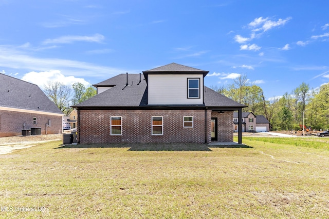 10243 March Meadows Way, Olive Branch, MS 38654 - rear view of house with a lawn, brick siding, roof with shingles, and central AC
