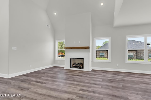 10243 March Meadows Way, Olive Branch, MS 38654 - unfurnished living room with high vaulted ceiling, a fireplace, wood finished floors, baseboards, and recessed lighting