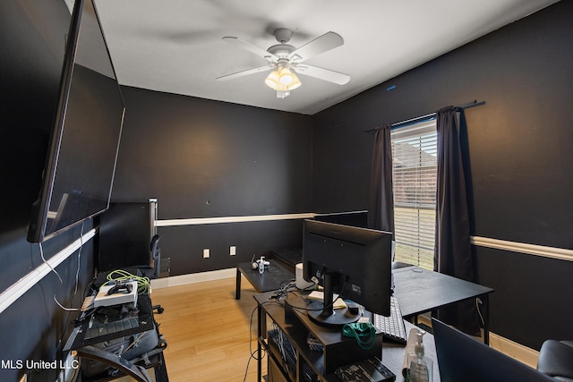 office with a ceiling fan, wood finished floors, and baseboards