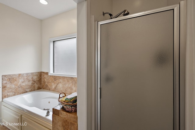 bathroom featuring a jetted tub and a stall shower