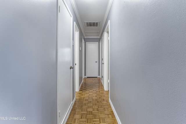 hall with ornamental molding and parquet flooring