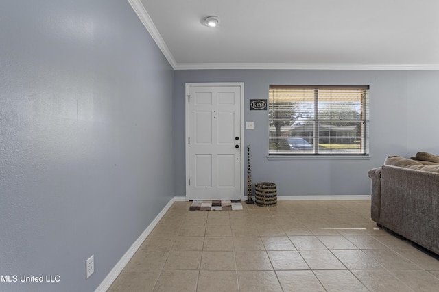 foyer entrance with light tile patterned floors and crown molding