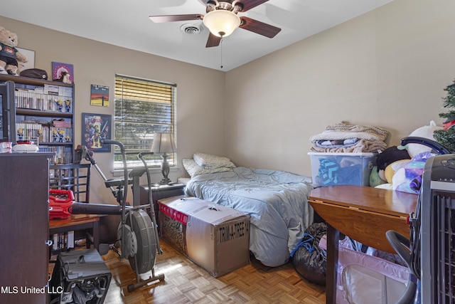 bedroom with ceiling fan and light parquet flooring