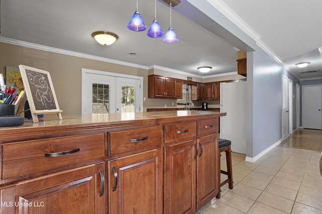 kitchen featuring french doors, crown molding, light tile patterned floors, white refrigerator, and decorative light fixtures