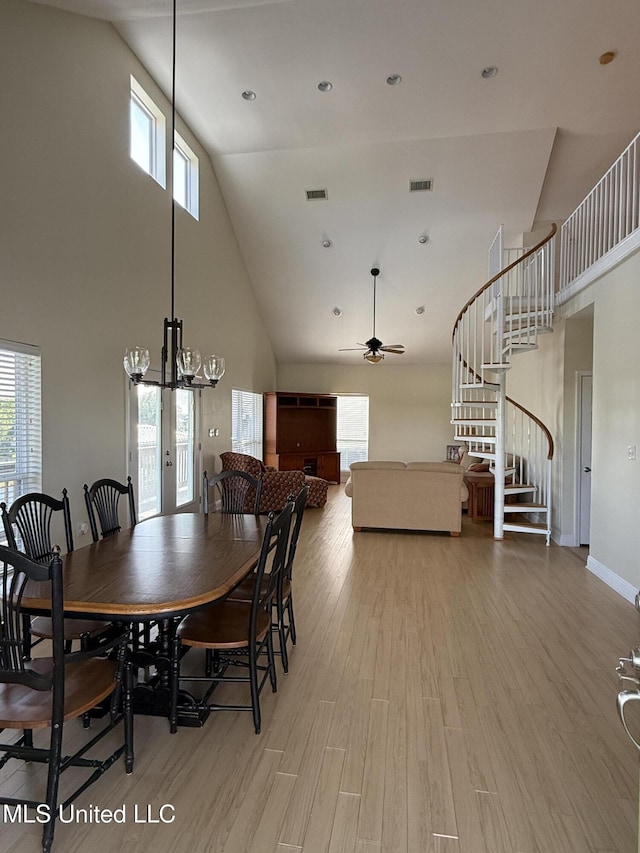 4013 Haiti St, Bay Saint Louis, MS 39520 - dining space with a wealth of natural light, visible vents, high vaulted ceiling, and stairs
