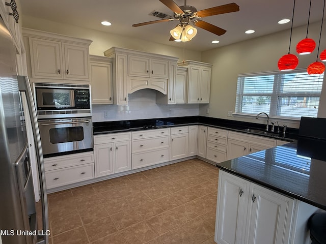 4013 Haiti St, Bay Saint Louis, MS 39520 - kitchen with a ceiling fan, a sink, pendant lighting, stainless steel appliances, and visible vents