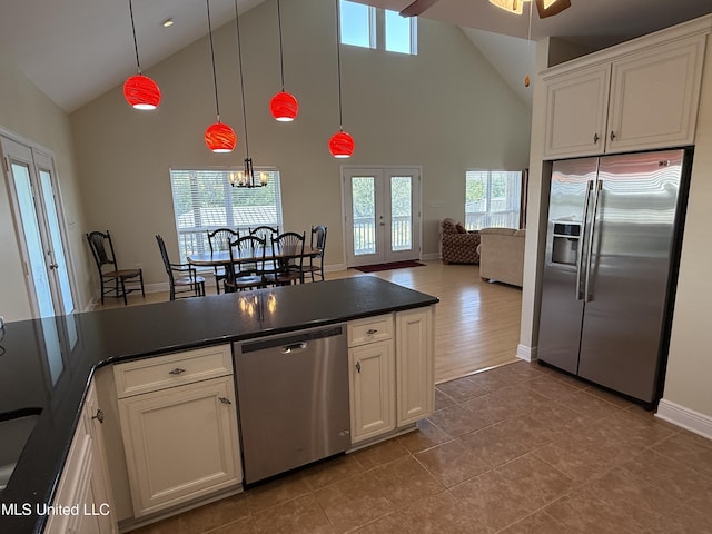 4013 Haiti St, Bay Saint Louis, MS 39520 - kitchen featuring white cabinets, french doors, dark countertops, high vaulted ceiling, and appliances with stainless steel finishes