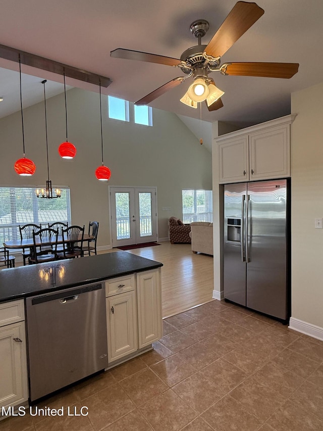 4013 Haiti St, Bay Saint Louis, MS 39520 - kitchen featuring dark countertops, white cabinetry, stainless steel appliances, and ceiling fan with notable chandelier