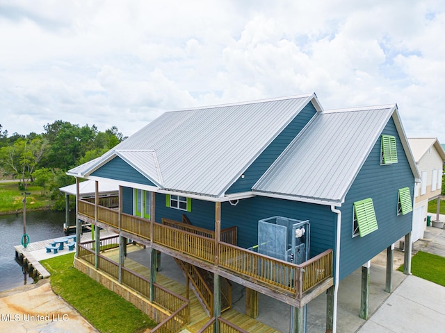 4013 Haiti St, Bay Saint Louis, MS 39520 - back of house with a carport, a deck with water view, and metal roof